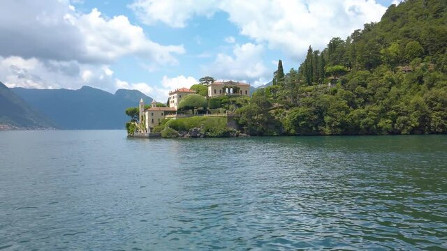 Sailing past the Villa del Balbianello, in lake Como, Italy. It is a beautiful sunny summer day. 4K editorial footage