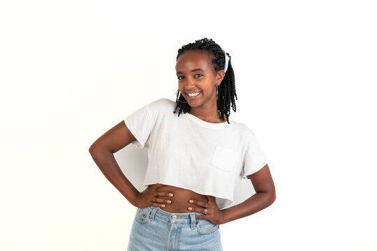 Happy woman smiling with her arms in the waist. White background. African-Ethiopian black woman.