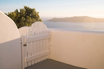 Close-up of small white gate in Imerovigli on Santorini island. Traditional white architecture of...