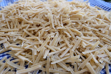 Preparing process of homemade Turkish noodle, selective focus. Noodles are the pasta that Turkish women make. It is called 