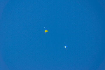 athletes parachutists soar in the blue sky