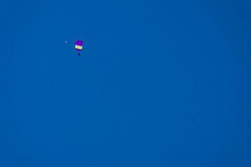 parachute with a purple kurol soars high in the sky