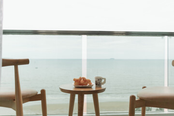 Table and chairs on the balcony with sea view. Summer travel concept.