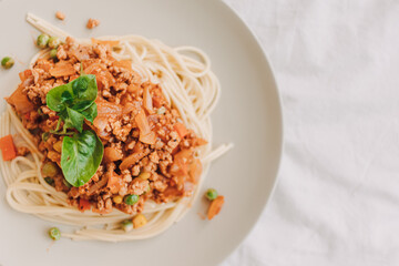 Homemade Spaghetti sauce with ground pork served in white dish.