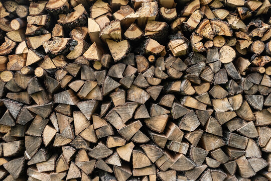 Stacked wood piles or firewood close up or texture or background
