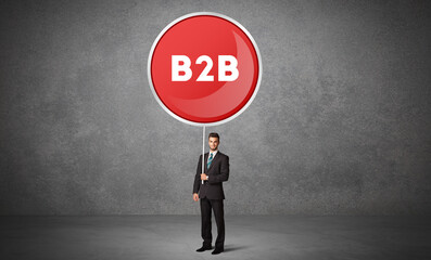 Young business person holdig traffic sign