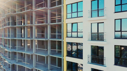 Many windows on new apartment building facade under construction. Real estate development.