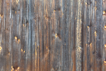 Weathered wooden surface covered with dark varnish as a background, texture, pattern.