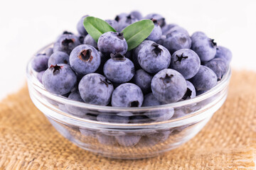 Fresh blueberries in a glass bowl.
Close-up.