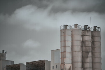 Concrete batching plant. Cement silos towers at construction site. Construction mixtures production