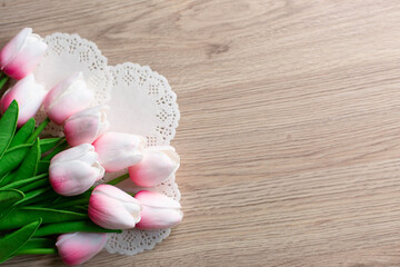 Fototapeta na wymiar bouquet of pink tulips on wooden background