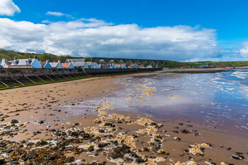 A view along the beach and sea wall at the town of  Cullen, Scotland on a summers day