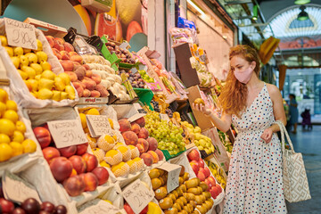 Young woman at the groceries street market