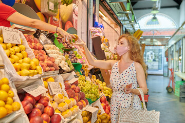Young woman at the groceries street market