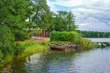 A beautiful summer day in the Turku archipelago (Finland). An old traditional red house and a...