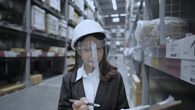 Business concept of 4k Resolution. Asian women intently inspecting items in the warehouse.