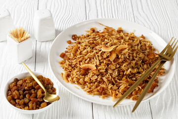 Coconut Rice with raisins on a plate, top view