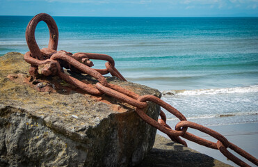 rusty anchor chain on the beach