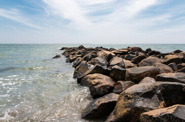 Fototapeta na wymiar Jetty of rock boulders extending out into the ocean in Narragansett Rhode Island