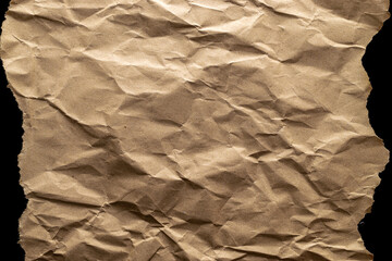Torn craft paper. Old craft vintage cardboard isolated on black. Torn kraft paper texture background. Recycled material concept.