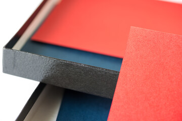 black paper box with red and blue paper