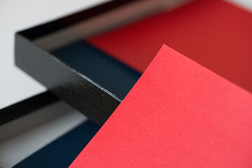 red paper resting on an open black cardboard box