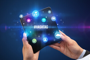 Businessman holding a foldable smartphone concept