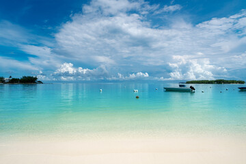 Idyllic tropical tourist destination on the Blue Bay beach with blue sea water in the summertime - Mauritius