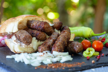 Grilled kebab, turkish style barbecued minced meat with onion. Traditional Balkan food - cevapi or...
