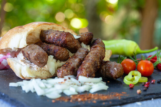 Grilled kebab, turkish style barbecued minced meat with onion. Traditional Balkan food - cevapi or cevapcici.