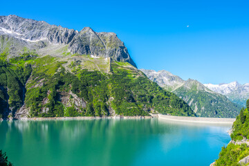 Beautiful alpine walley with azure blue water of Specher Zillergrundl dam, Zillertal Alps, Austria