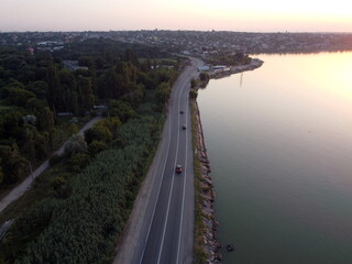 road near a pond with transport from a drone