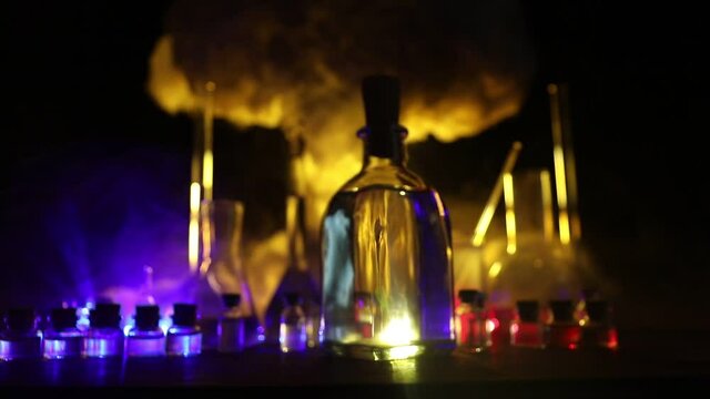 Pharmacy and chemistry theme. Test glass flask with solution in research laboratory. Science and medical background. Laboratory test tubes on abstract explosion cloud background. Selective focus
