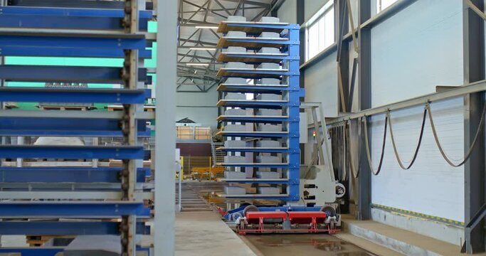 Modern automated stacker carries concrete parts to the warehouse shelves. Logistics in the warehouse of the plant, modern production, loading. 4k, ProRes