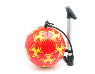 Orange soccer ball with pump on white background