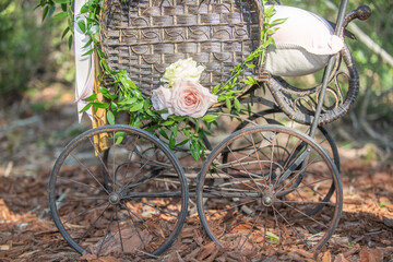 Old rusted wagon wheel rim spoke attached to wood as yard decor fashioned wheel cart baby carriage...