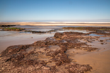 Sand, rocks and waves in a beach