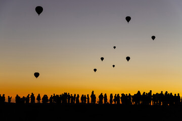 The silhouette of ballons rising at the sunrise in Cappadocia, Turkey