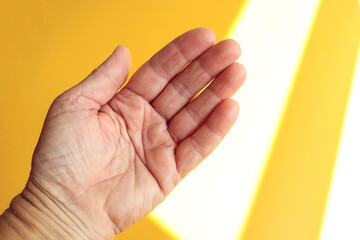 The concept of predicting a person's fate along the lines of life. The hand of an elderly woman on...