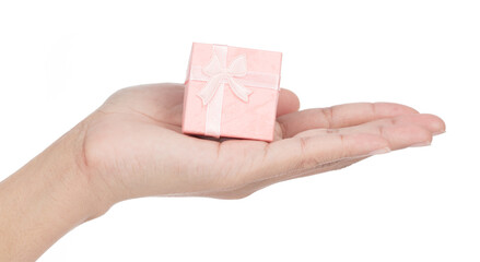 Hand holding Pink gift box with ribbon and bow isolated on white background