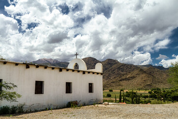 Fototapeta na wymiar Side view of the San Antonio de Padua chapel with hills in the background, near the town of Cachi, in Salta, Argentina