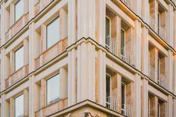 Corner of yellow facade of a historic building. Architecture. Design. Style. City. Urban