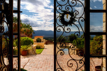 Entrance to a vineyard farm seen through a gate in Salta, Argentina