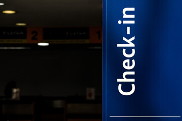 Check-in sign at an empty airport