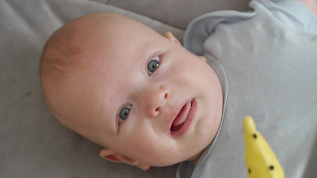 Face of unhappy three month old baby boy. High quality 4k footage