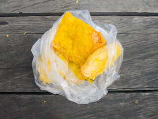 fried banana and tempeh in a white plastic bag