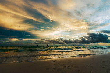 Dramatic sunset with with a view of salibotats over White beach in Boracay Island, Philippines.  Travel and nature.