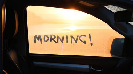 A beautiful golden morning sunrise looking over a beach through a car window. The message 'morning'...