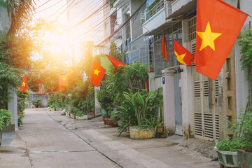 Vietnamese flags are hung from the houses - 449618588