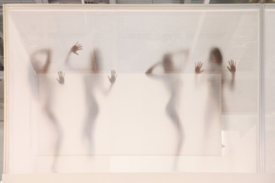 Blurred background of four female silhouettes without clothes
